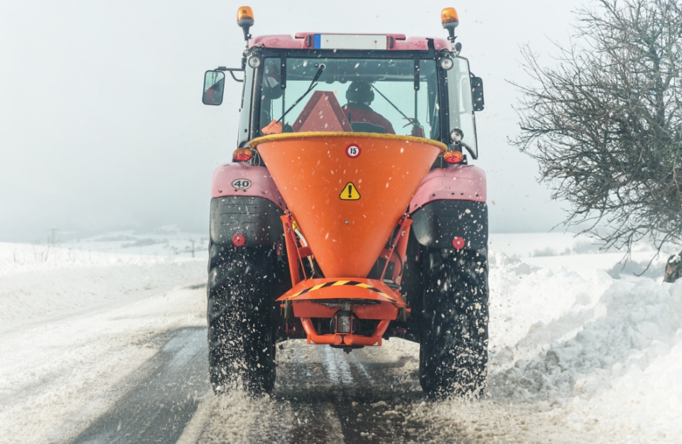 Snow plow plowing the road