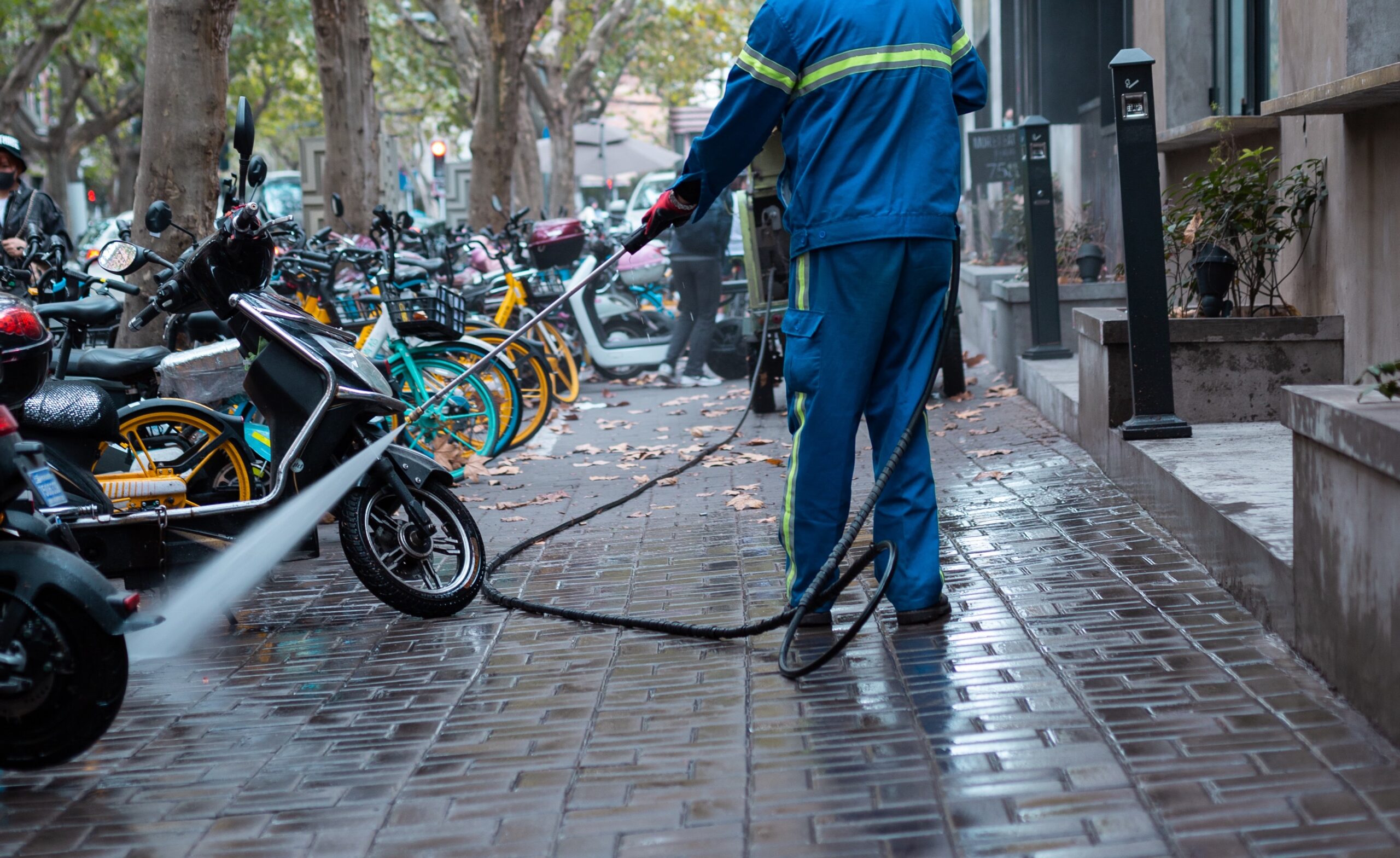 person power washing the street