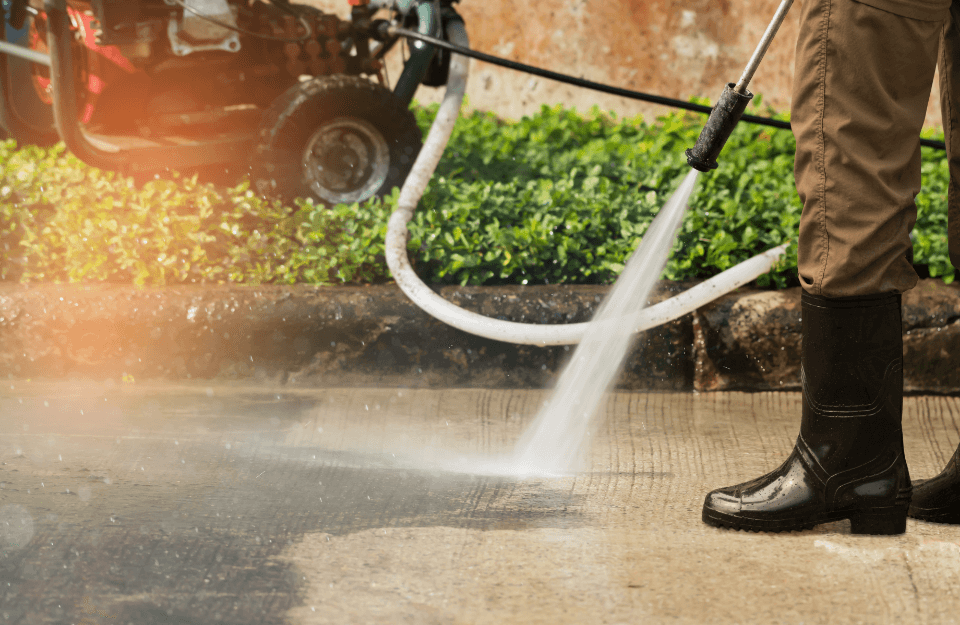 person power washing the street